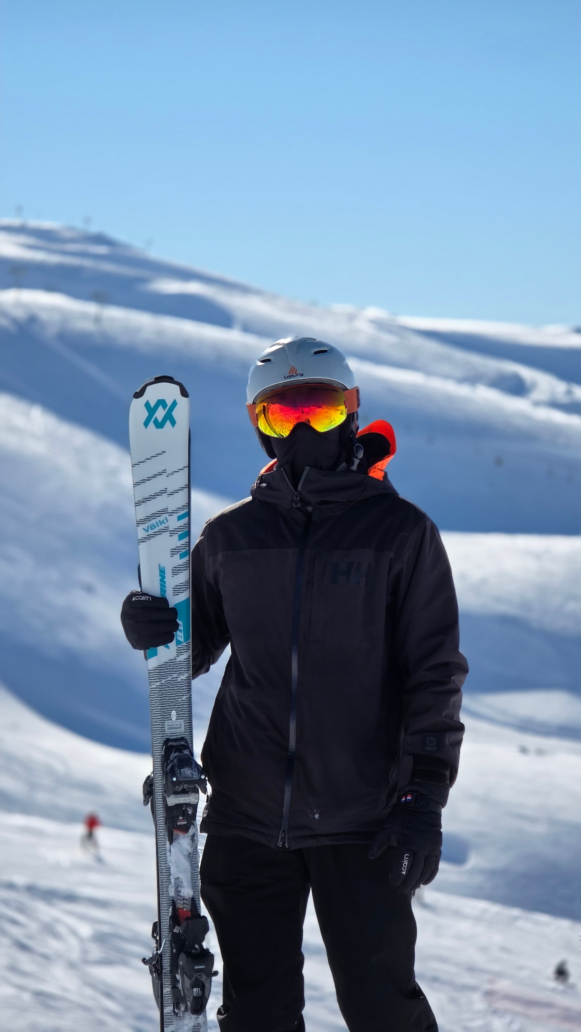 Charbel holding skis on a snowy mountain